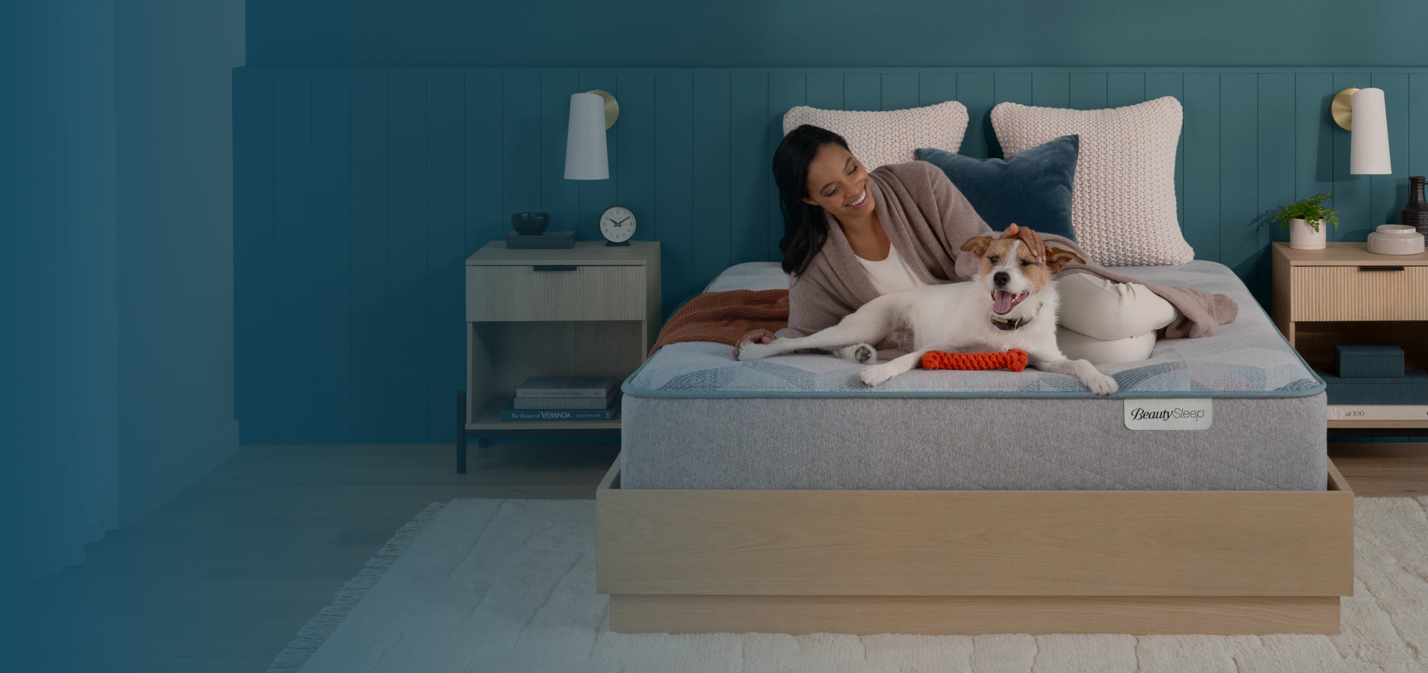 Woman laying on a Beautysleep mattress with her dog.